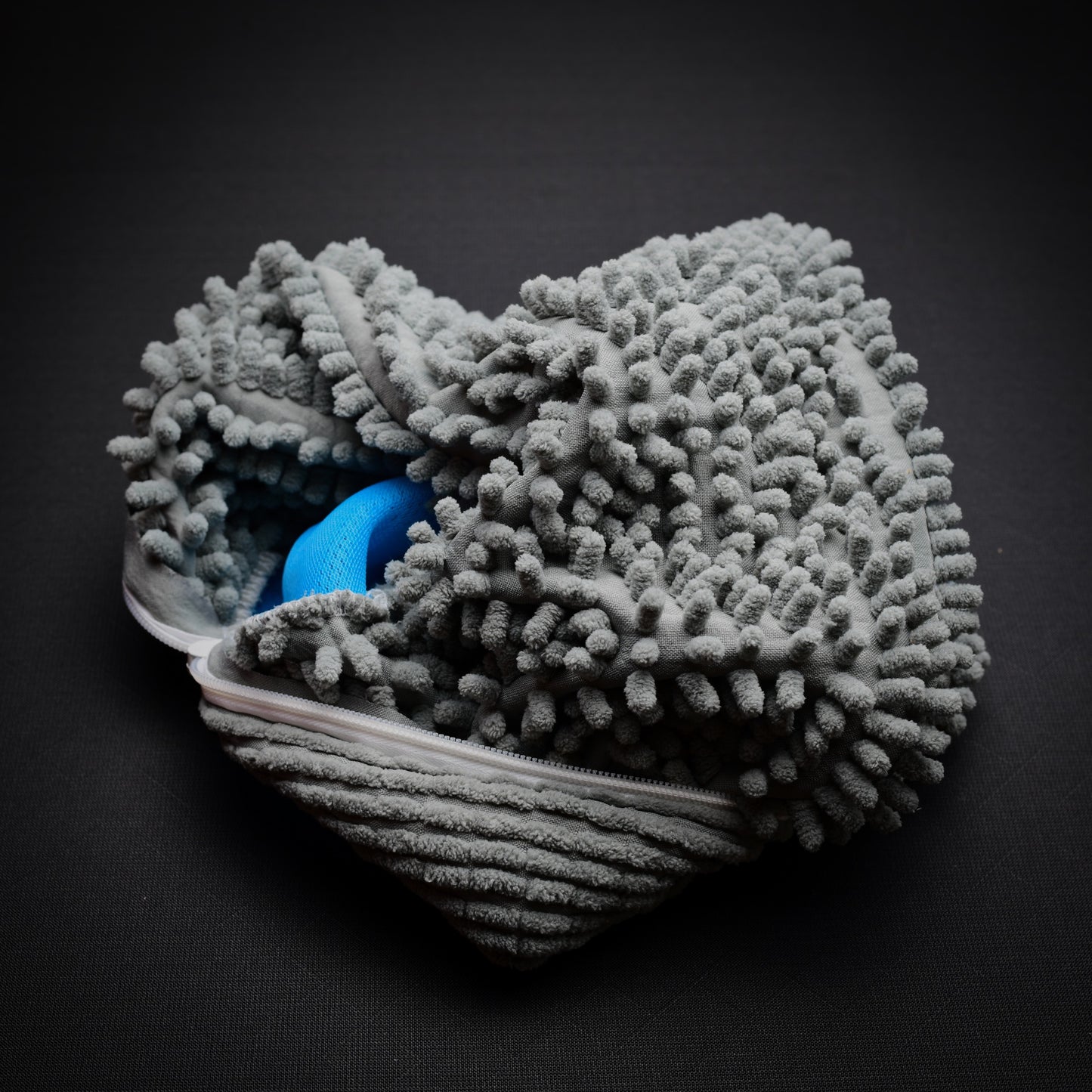 Open microfibre trail shoe wash bag showing soft cleaning studs that help loosen mud and protect trail shoes during the wash cycle.