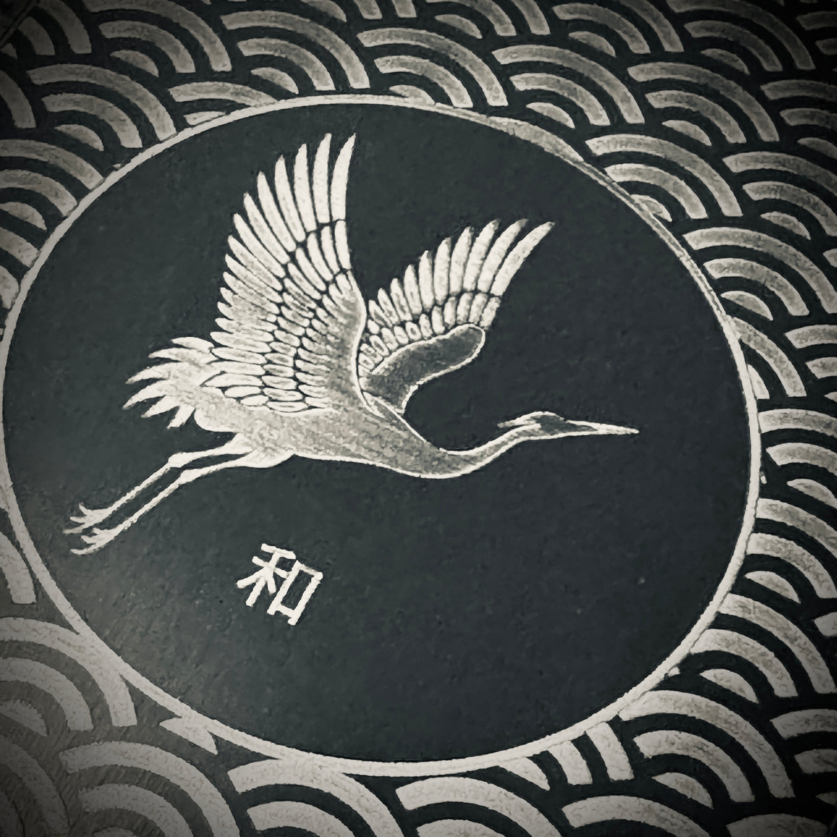 1. Close-up of the Harmony titanium art card showing detailed crane engraving and 和 kanji for harmony.