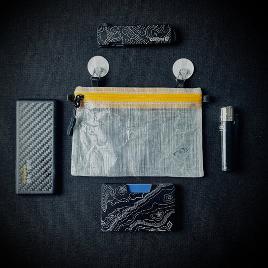 DCF organiser pouch with Microdots, shown alongside a power bank, wallet, lighter and small tool.