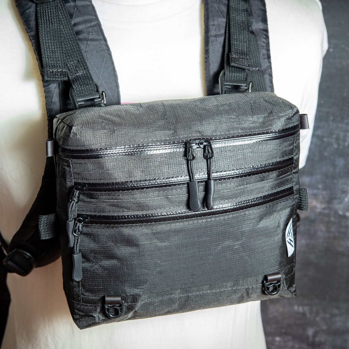 Ultra 200X 3L backpacking chest pack attached to backpack shoulder straps with quick-release buckles.