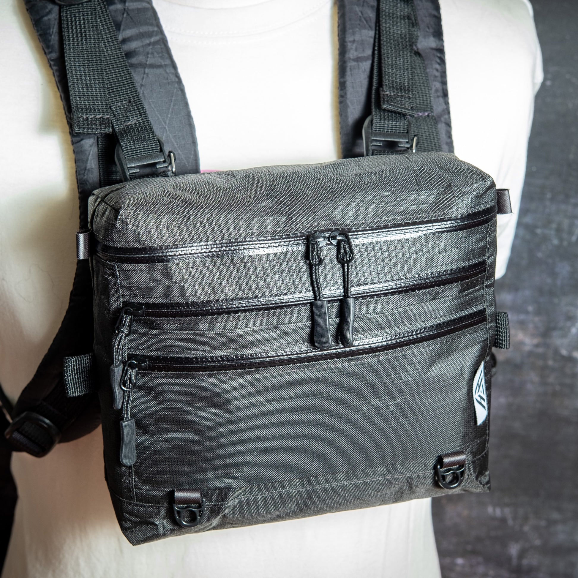 Ultra 200X 3L backpacking chest pack attached to backpack shoulder straps with quick-release buckles.