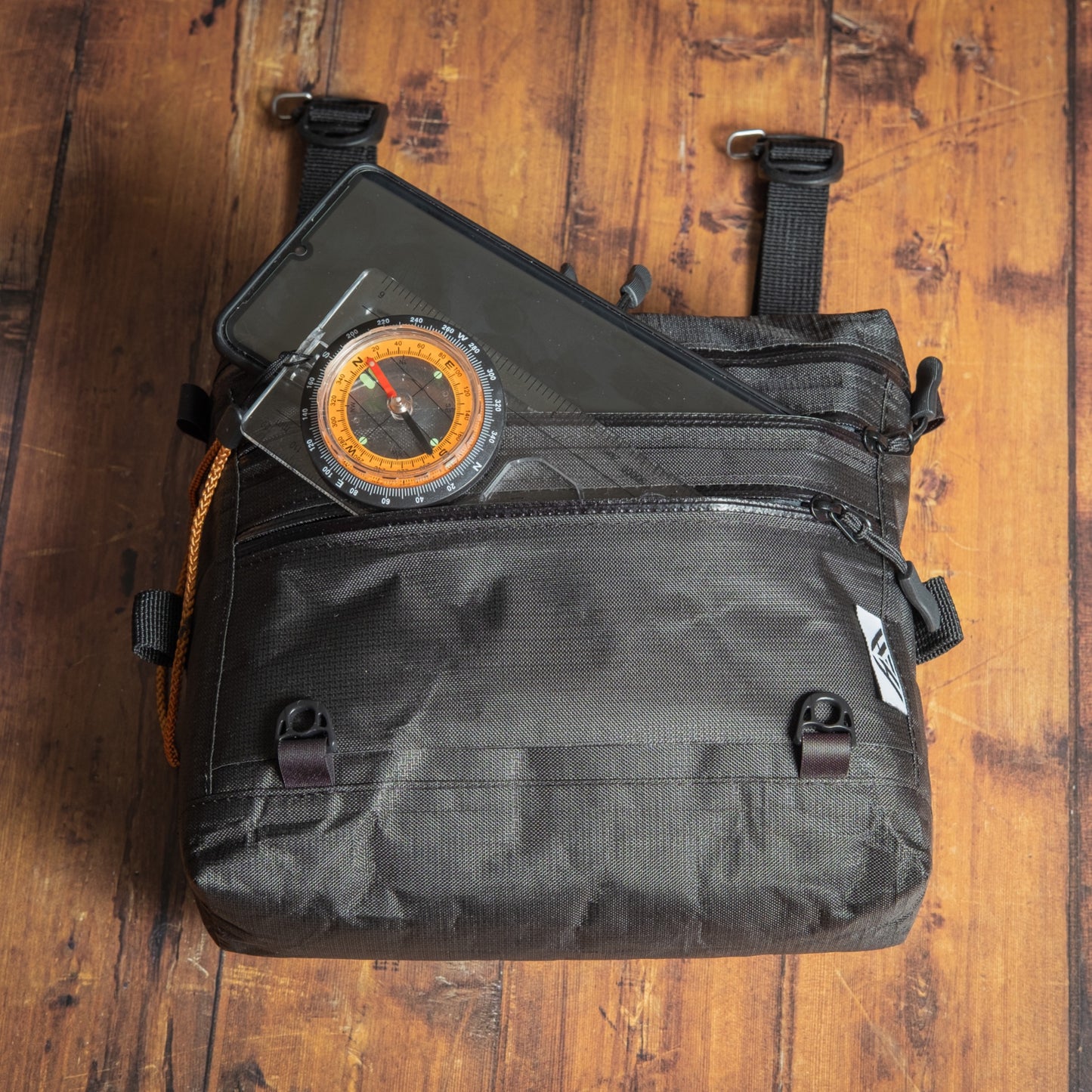 Ultra 200X chest pack with large external pocket holding a smartphone and baseplate compass