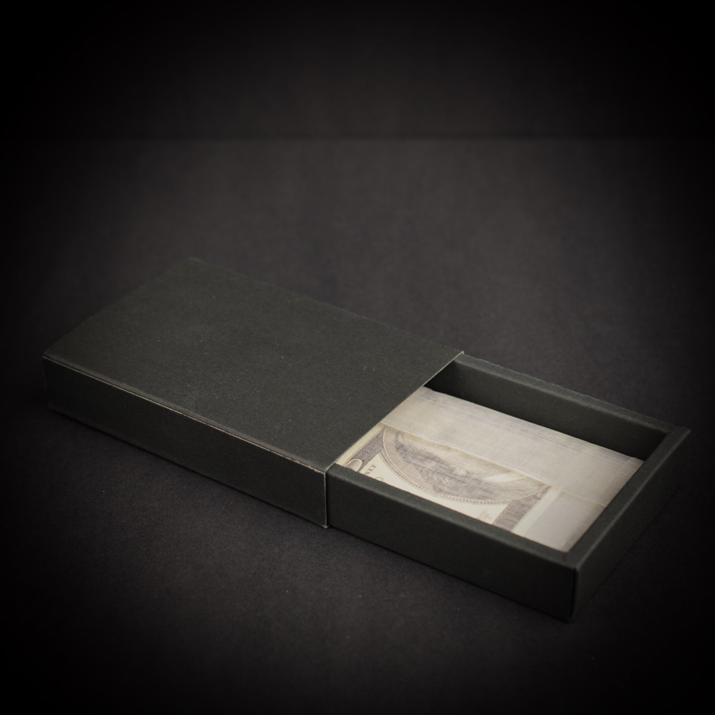 Ultralight Dyneema Composite Fabric adventure wallet presented in a black gift box with folded cash visible inside.
