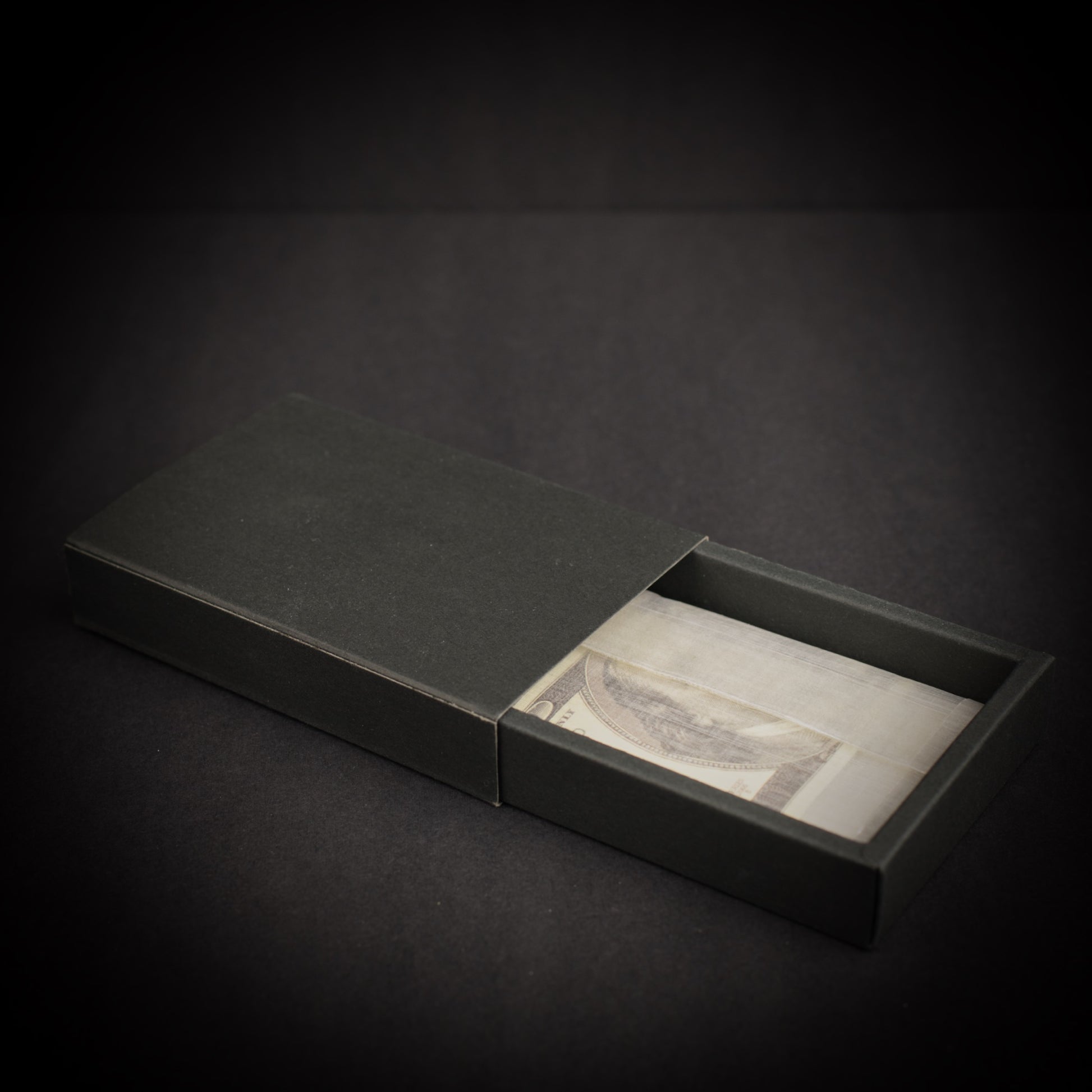 Ultralight Dyneema Composite Fabric adventure wallet presented in a black gift box with folded cash visible inside.