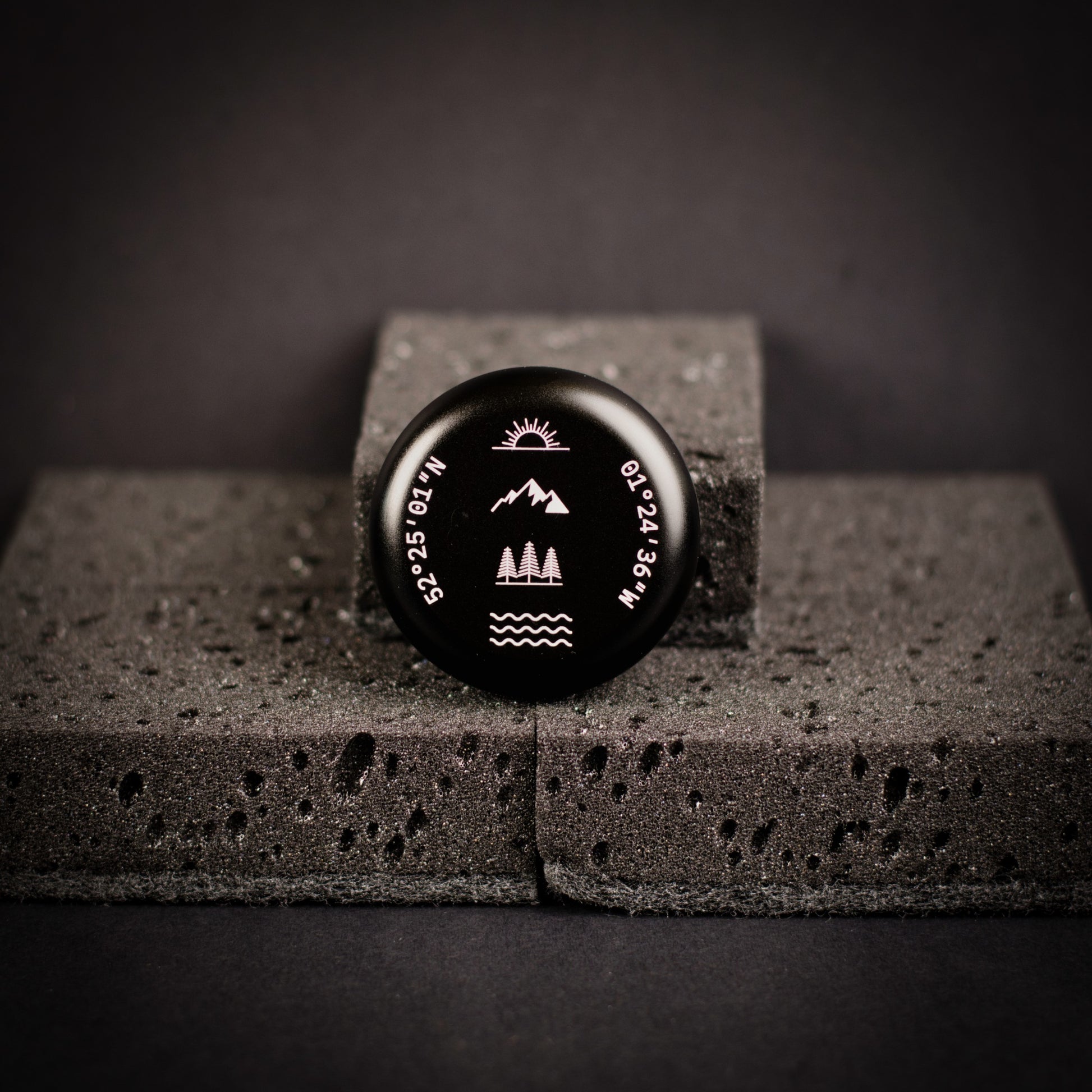 Black personalised portable incense burner with engraved coordinates and nature-inspired symbols.