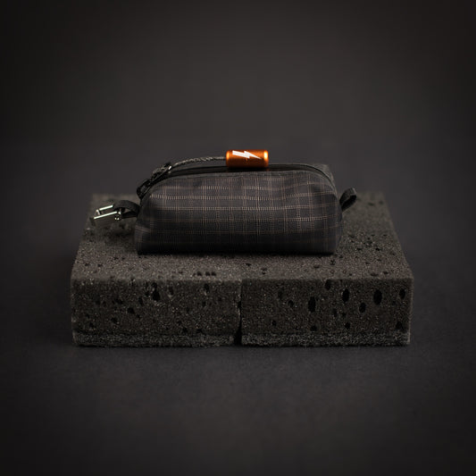 Ultralight pouch fitted with orange power gear identifier zipper pull on Dyneema cord loop.