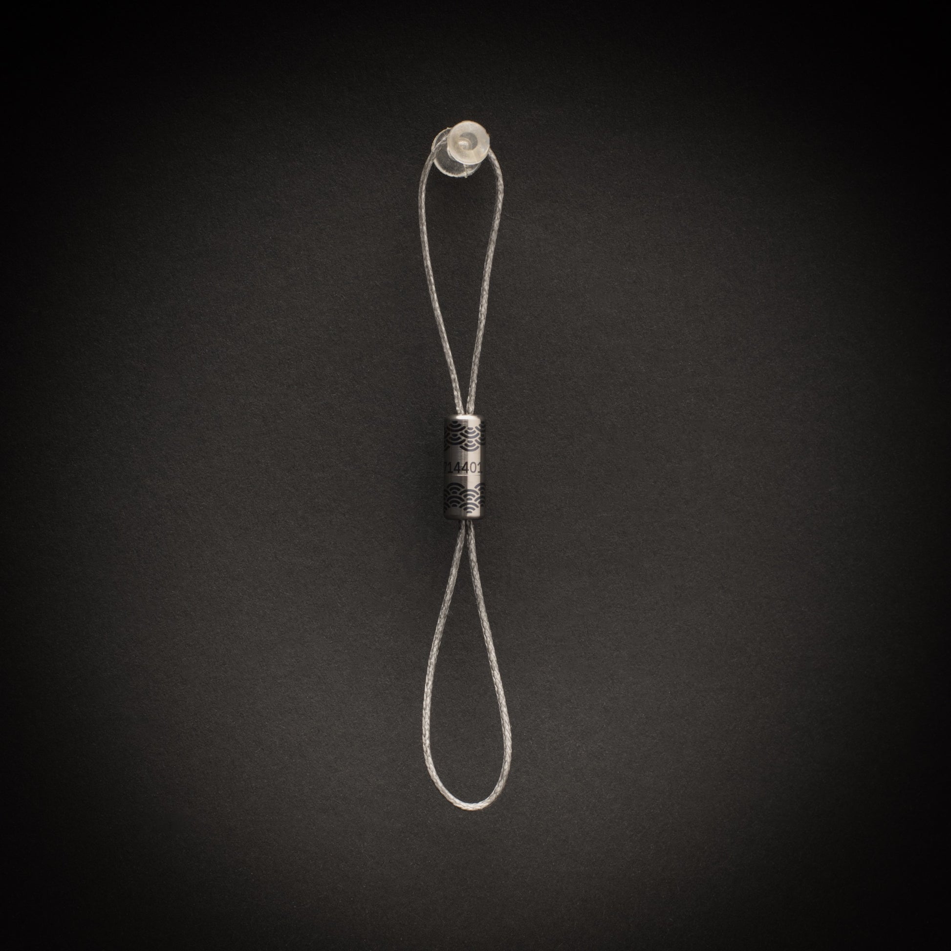 Close-up of personalised titanium Bow-Ti showing permanent laser engraving and Seigaiha wrap