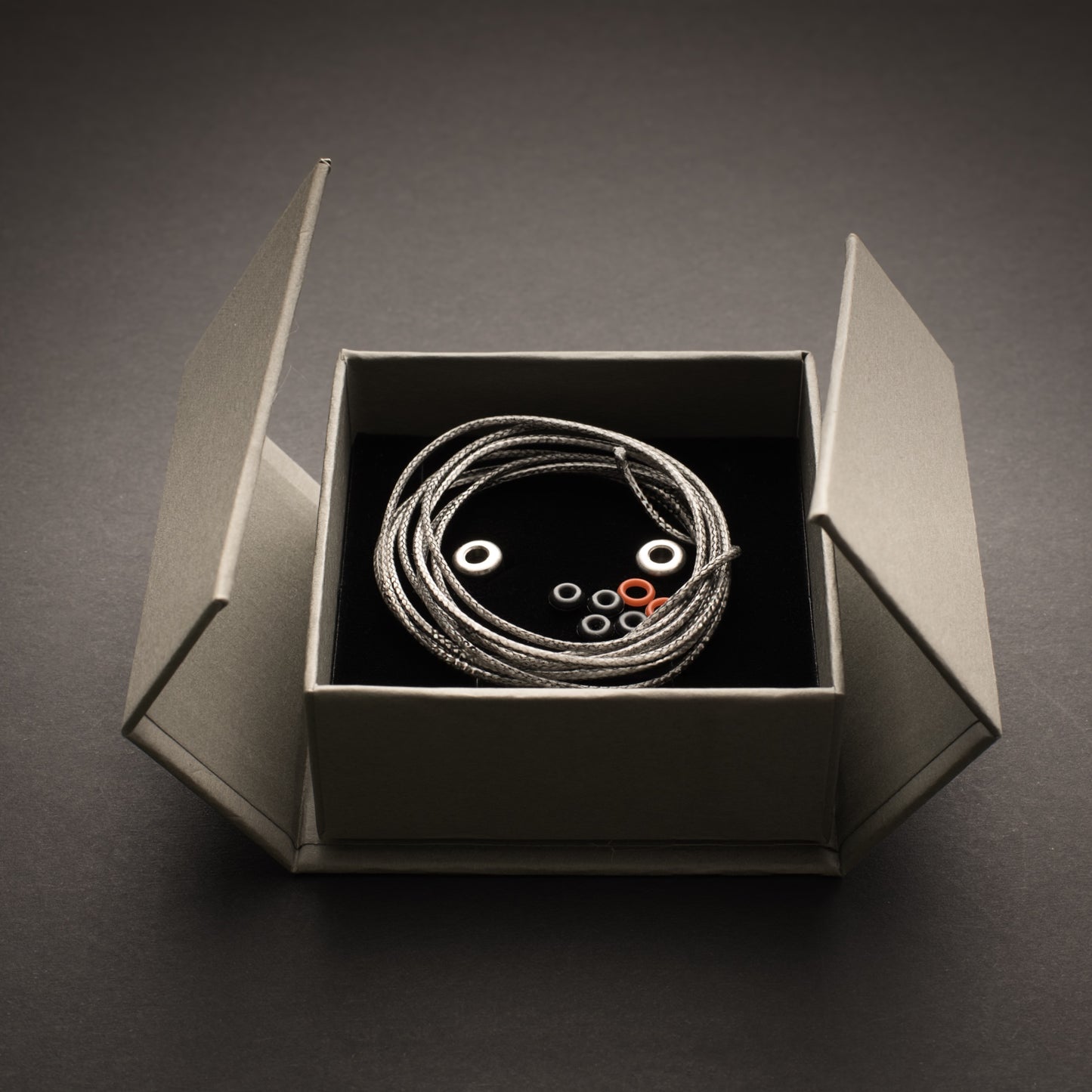 Bow-Ti titanium link presented in magnetic gift box with Dyneema cord, O-rings and spare components