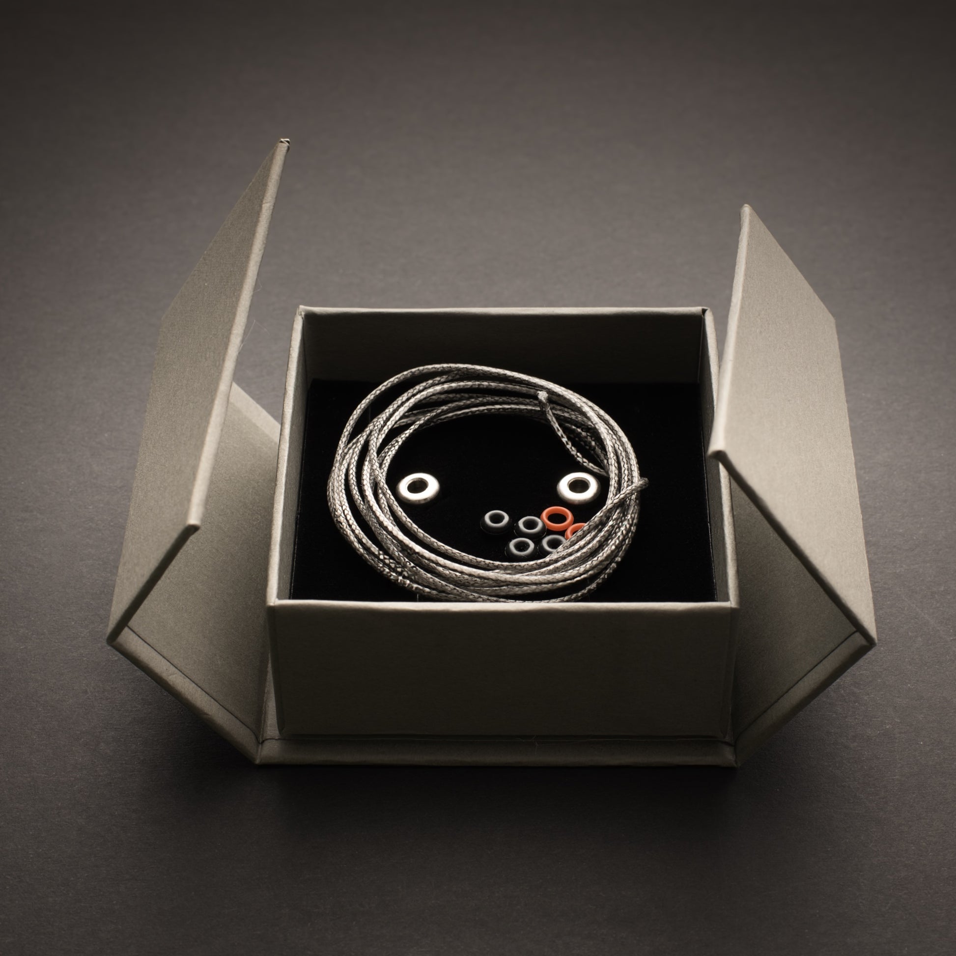 Bow-Ti titanium link presented in magnetic gift box with Dyneema cord, O-rings and spare components