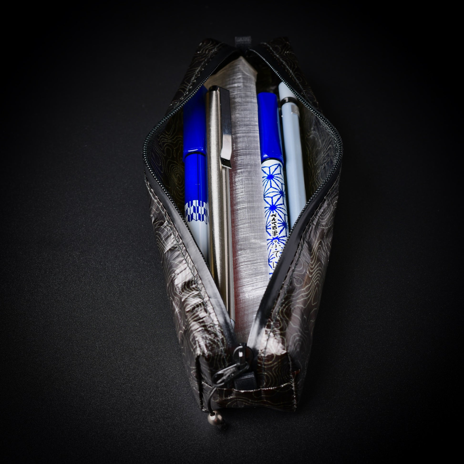Open Dyneema Topo Writing Instrument Case holding  pens, markers and pencils