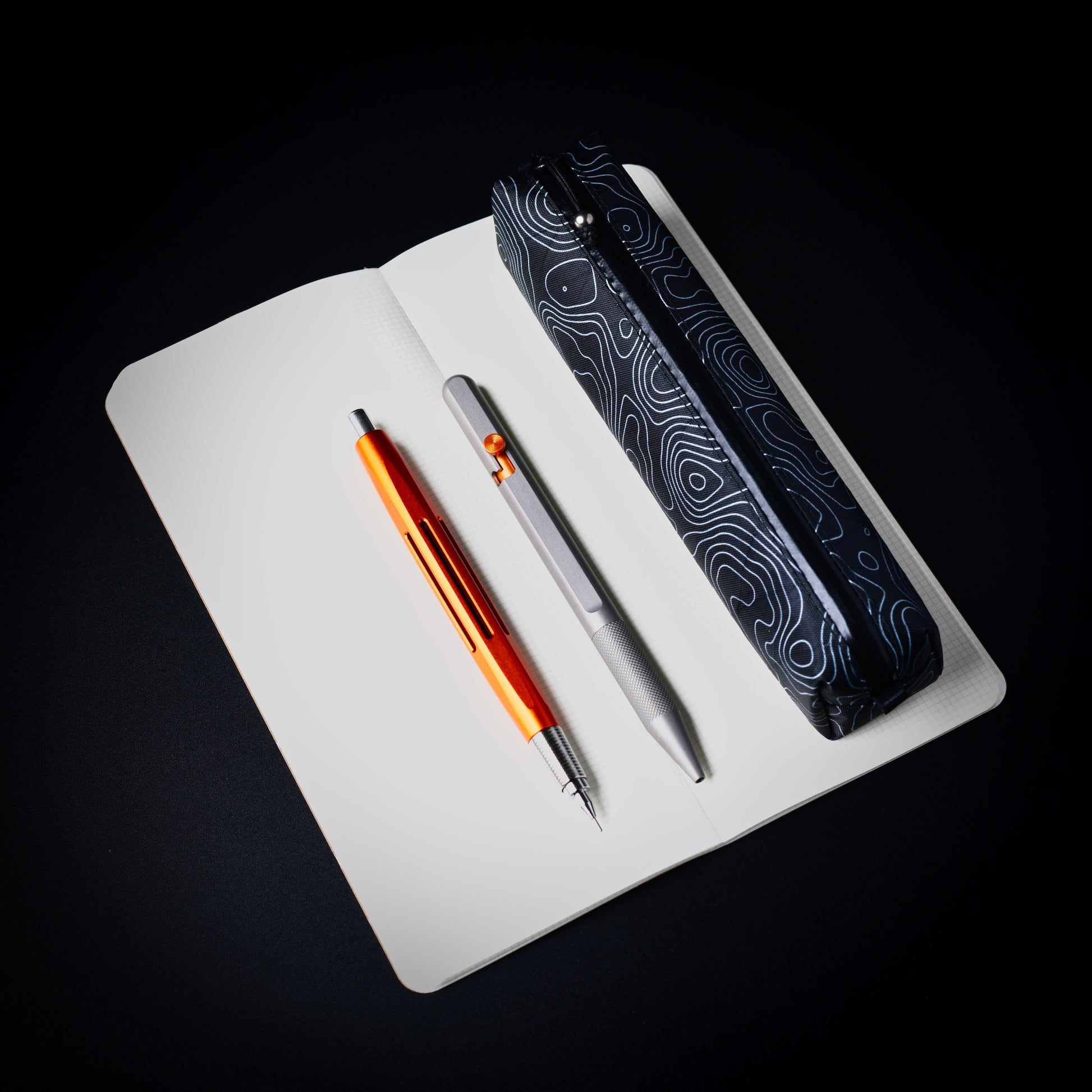 VX15 X-Pac Topo Writing Instrument Case shown with notebook and writing instruments.