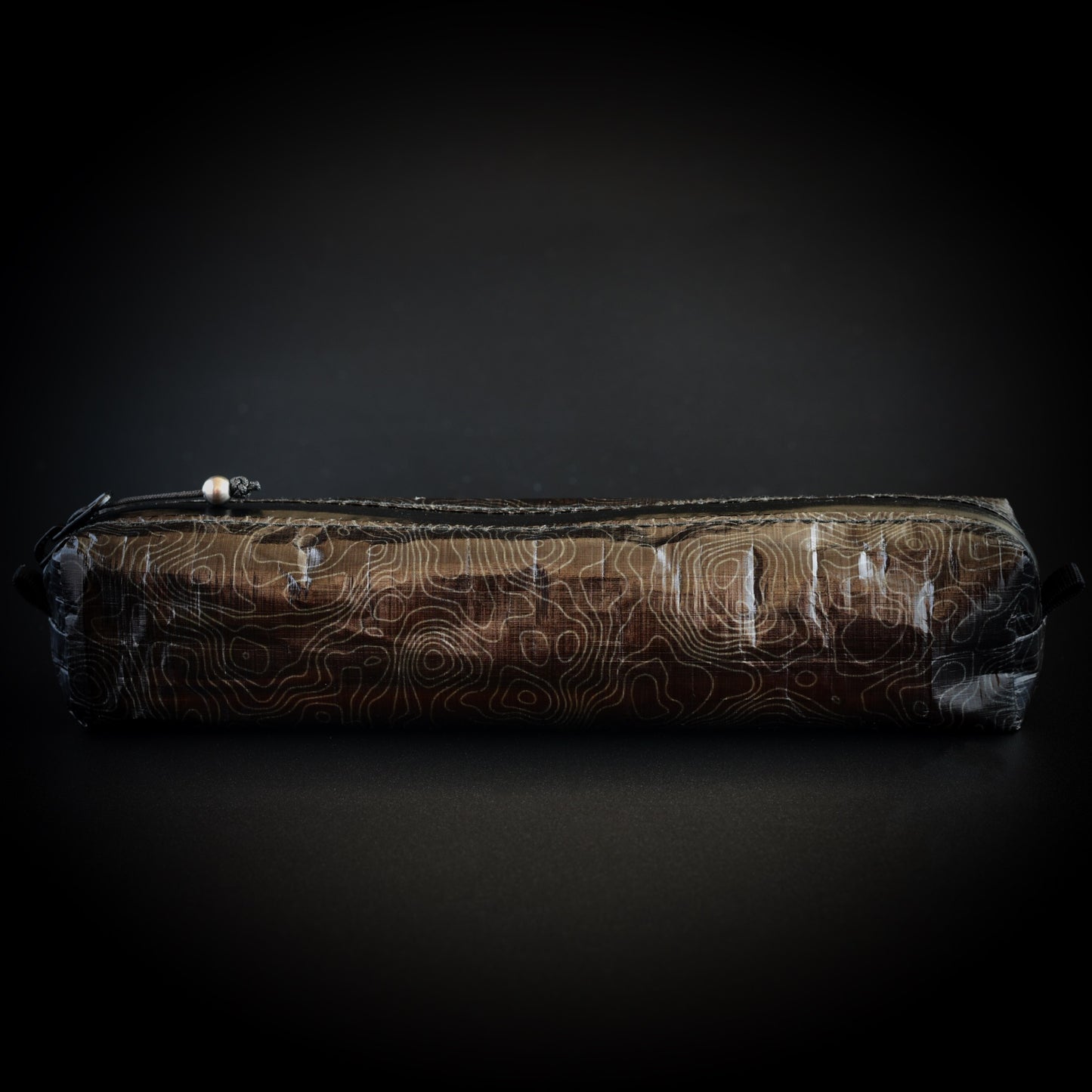 Topo Writing Instrument Case in 1.43 oz Dyneema Composite Fabric with topographic line pattern.