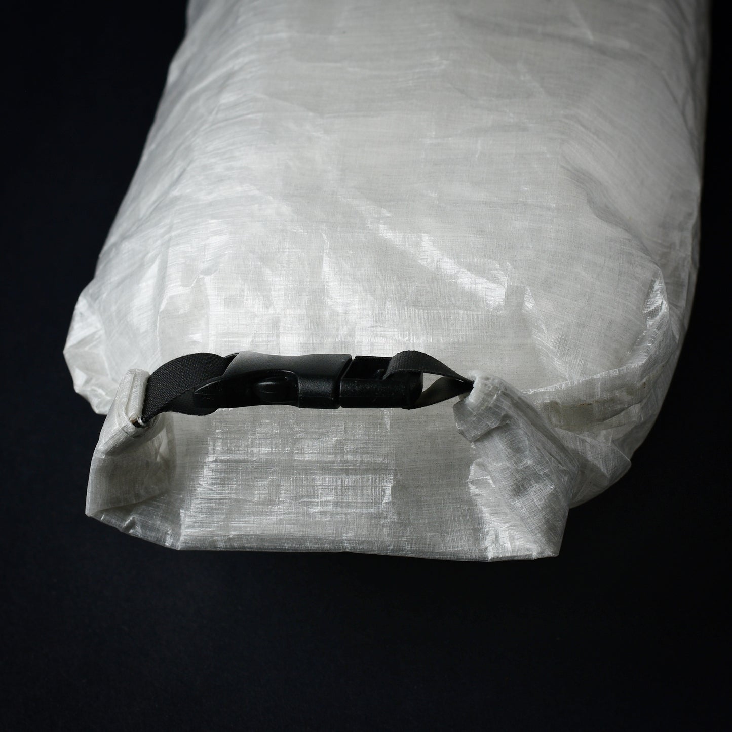 Rear view of Dyneema first aid dry bag showing roll-top closure with side-release buckle and seam-sealed construction.