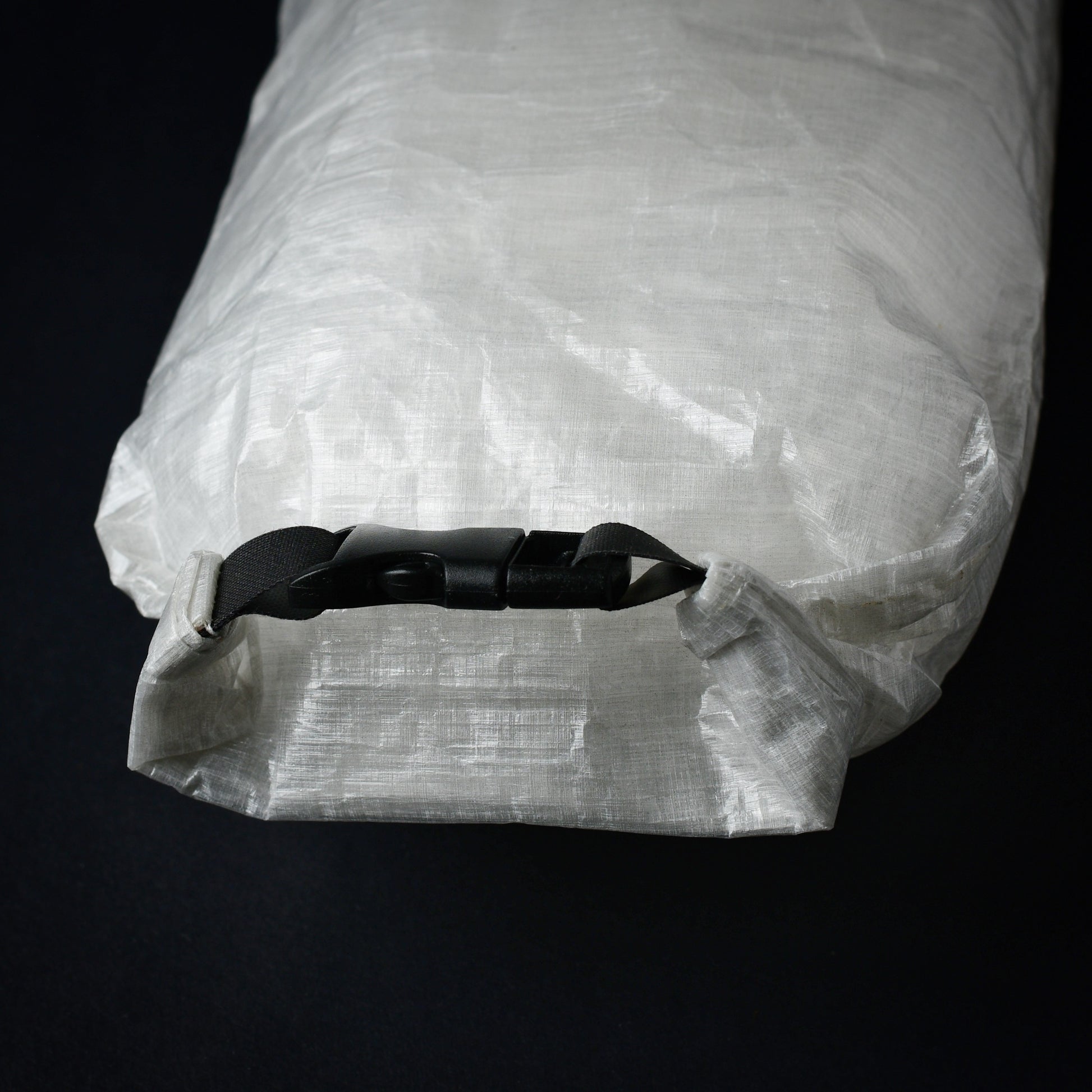Rear view of Dyneema first aid dry bag showing roll-top closure with side-release buckle and seam-sealed construction.