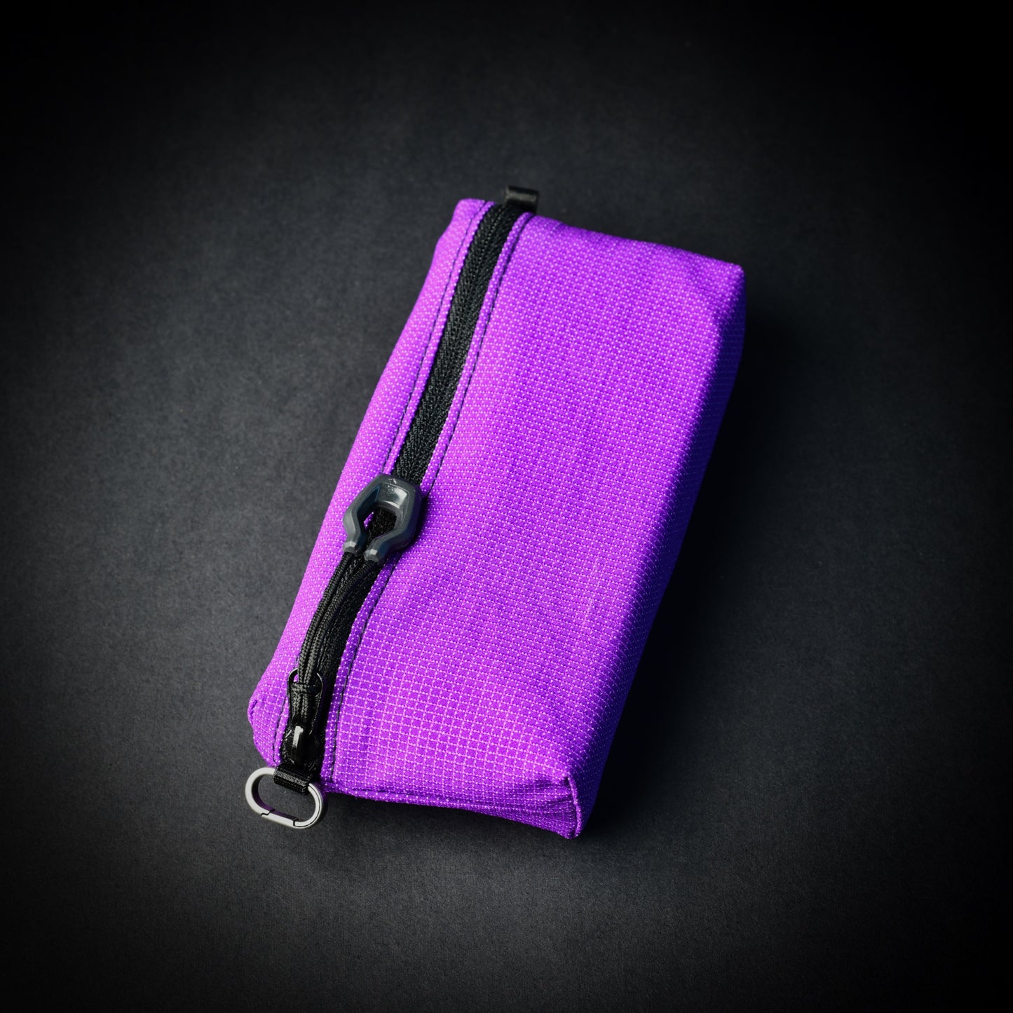 Purple UltraStretch™ expandable accessory case with reversed YKK® zip, glove-compatible zip pull and titanium micro carabiner.