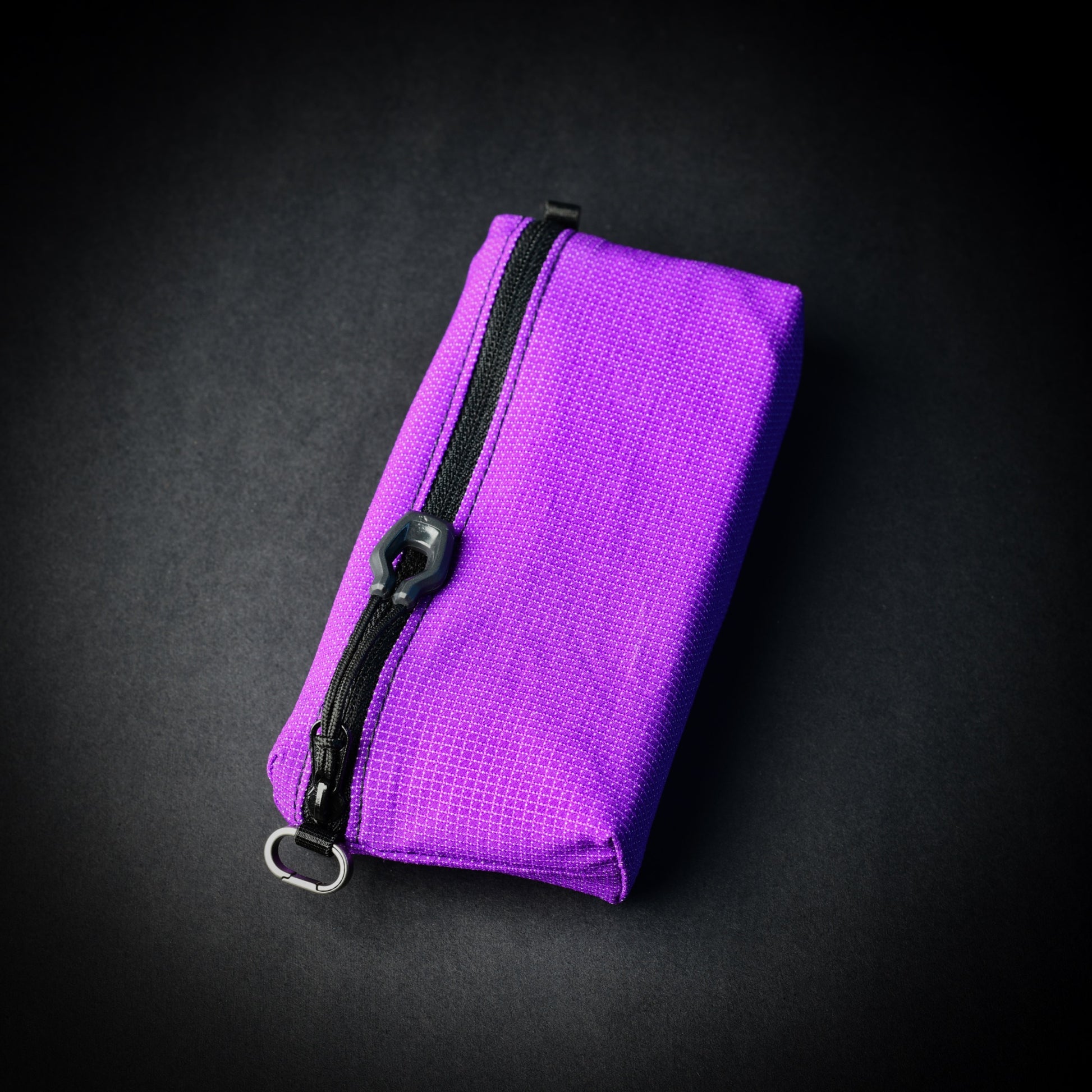 Purple UltraStretch™ expandable accessory case with reversed YKK® zip, glove-compatible zip pull and titanium micro carabiner.