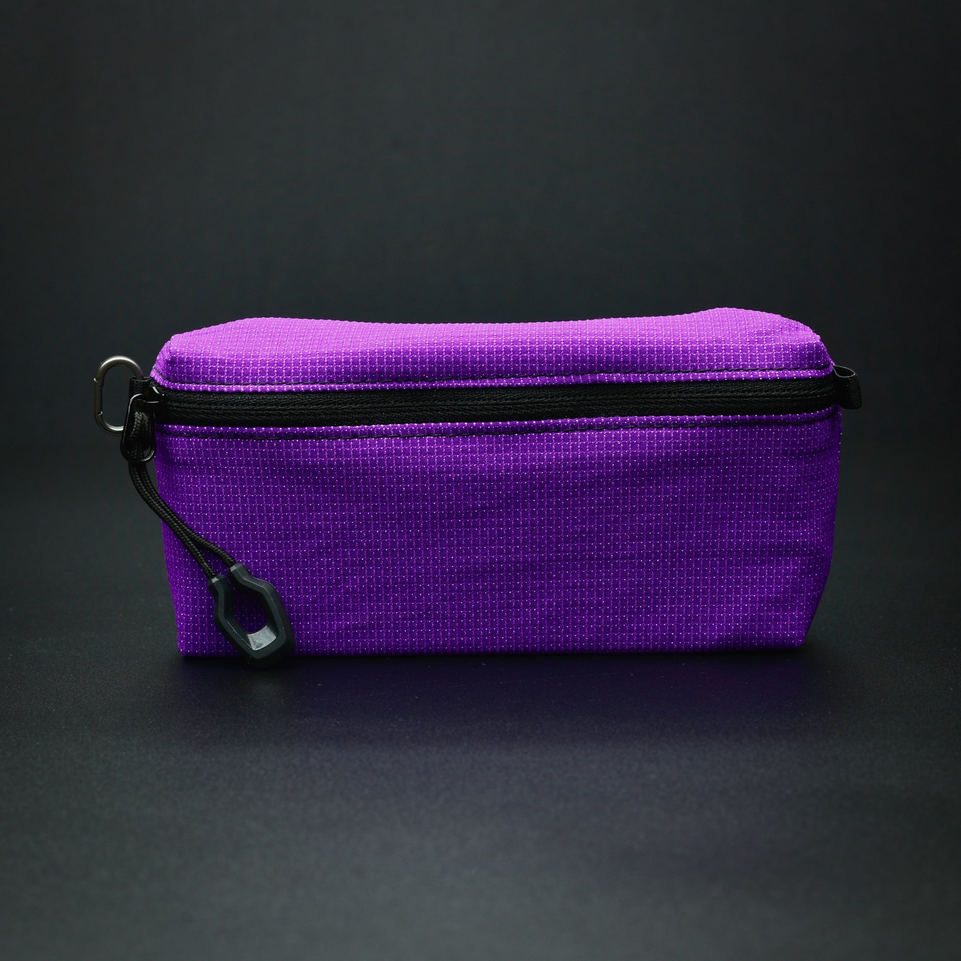 Side profile of a purple UltraStretch™ accessory case showing its expandable construction and reversed YKK® zip.