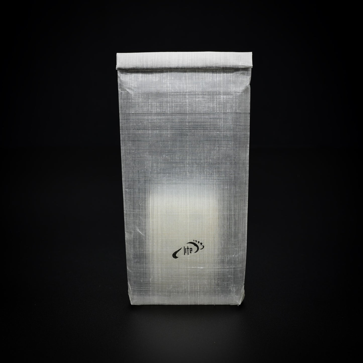 Transparent Dyneema® Composite Fabric power bank dry bag standing upright with a Nitecore NB10000 visible through the fabric.