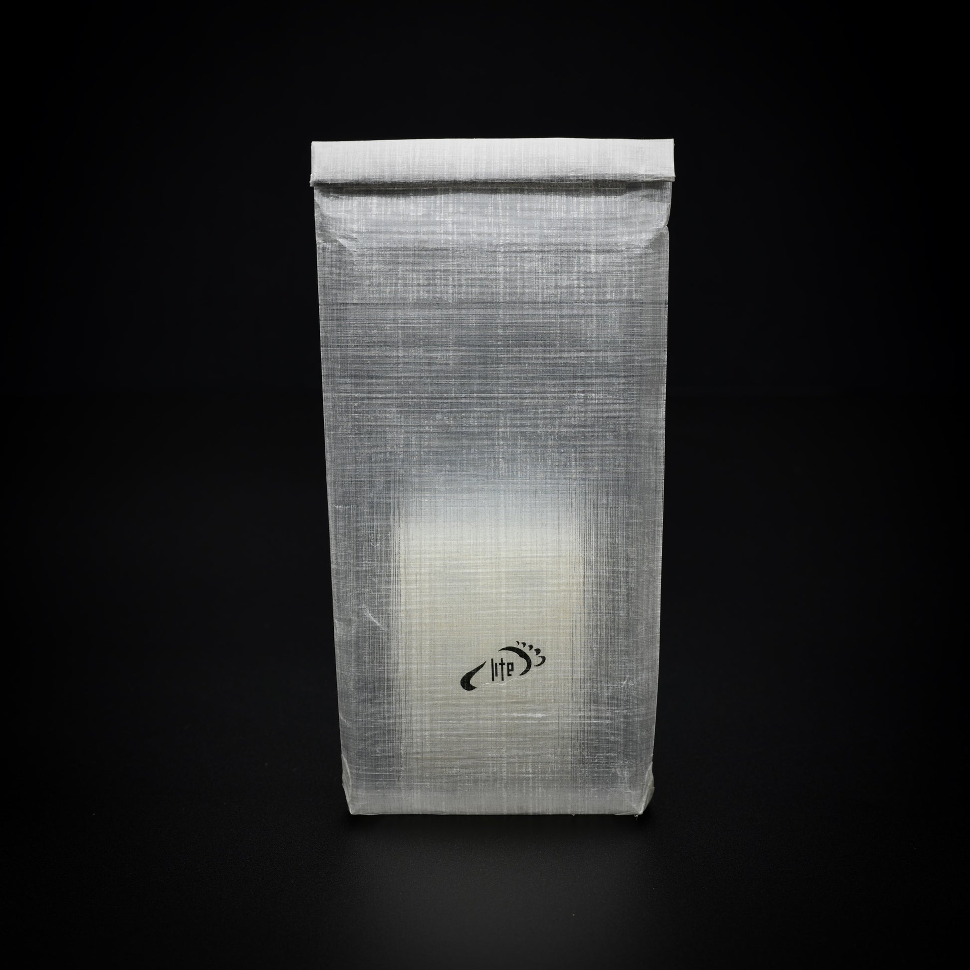 Transparent Dyneema® Composite Fabric power bank dry bag standing upright with a Nitecore NB10000 visible through the fabric.