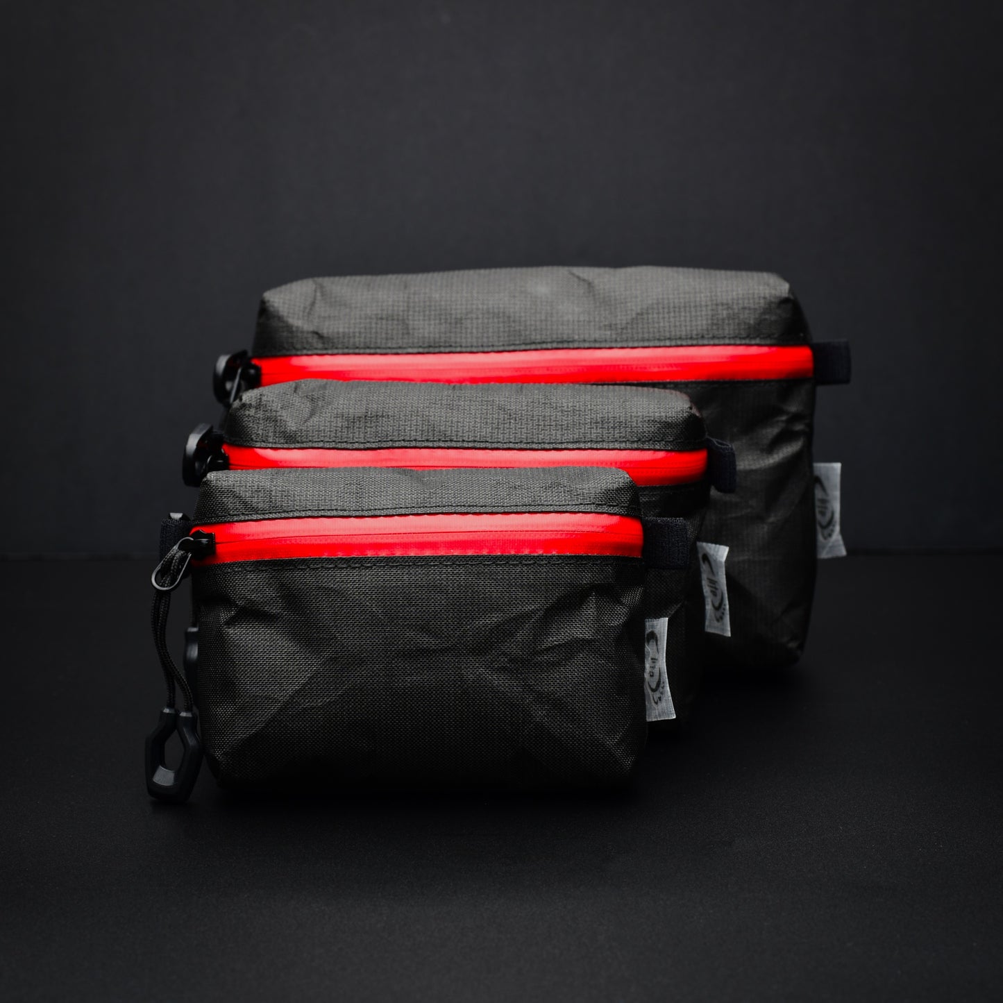 Small, medium and large EcoPak Ultra™ gusseted zip pouches with red YKK® AquaGuard® zips.