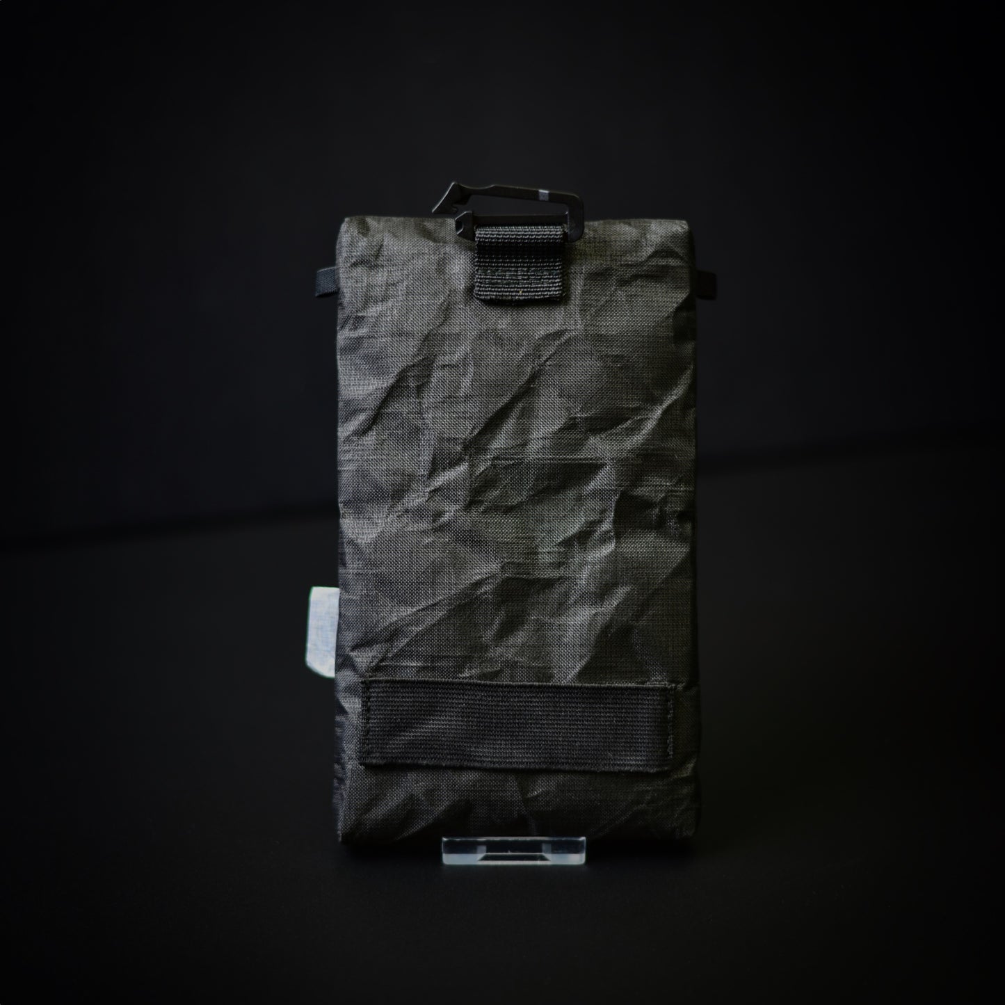 Rear view of an Ultra 200X backpack strap phone pouch showing reinforced attachment system with G-hook and lower stabilising strap.