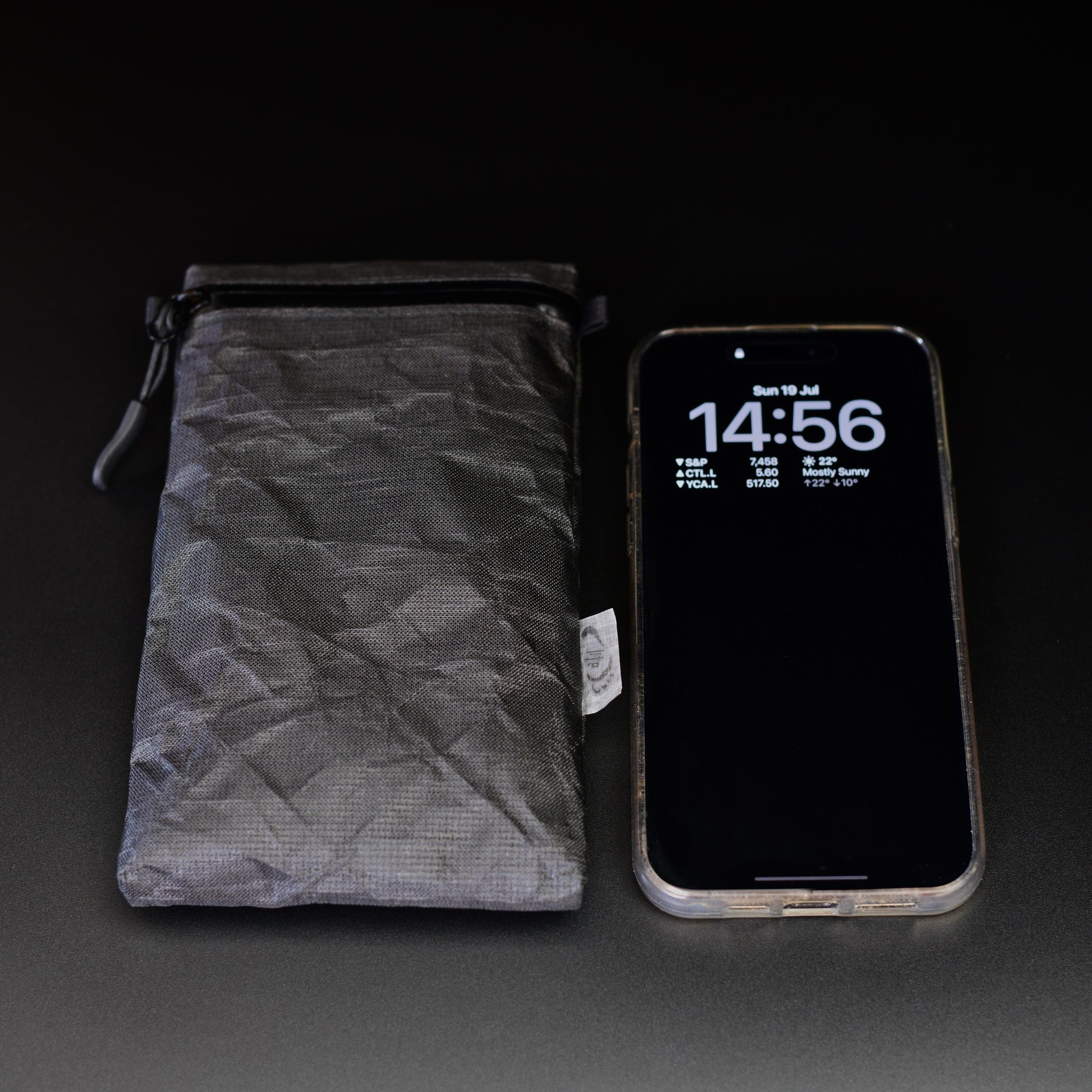 Ultra 200X backpack strap phone pouch beside an iPhone for size comparison, sized to fit all iPhone and Samsung Galaxy Max models.