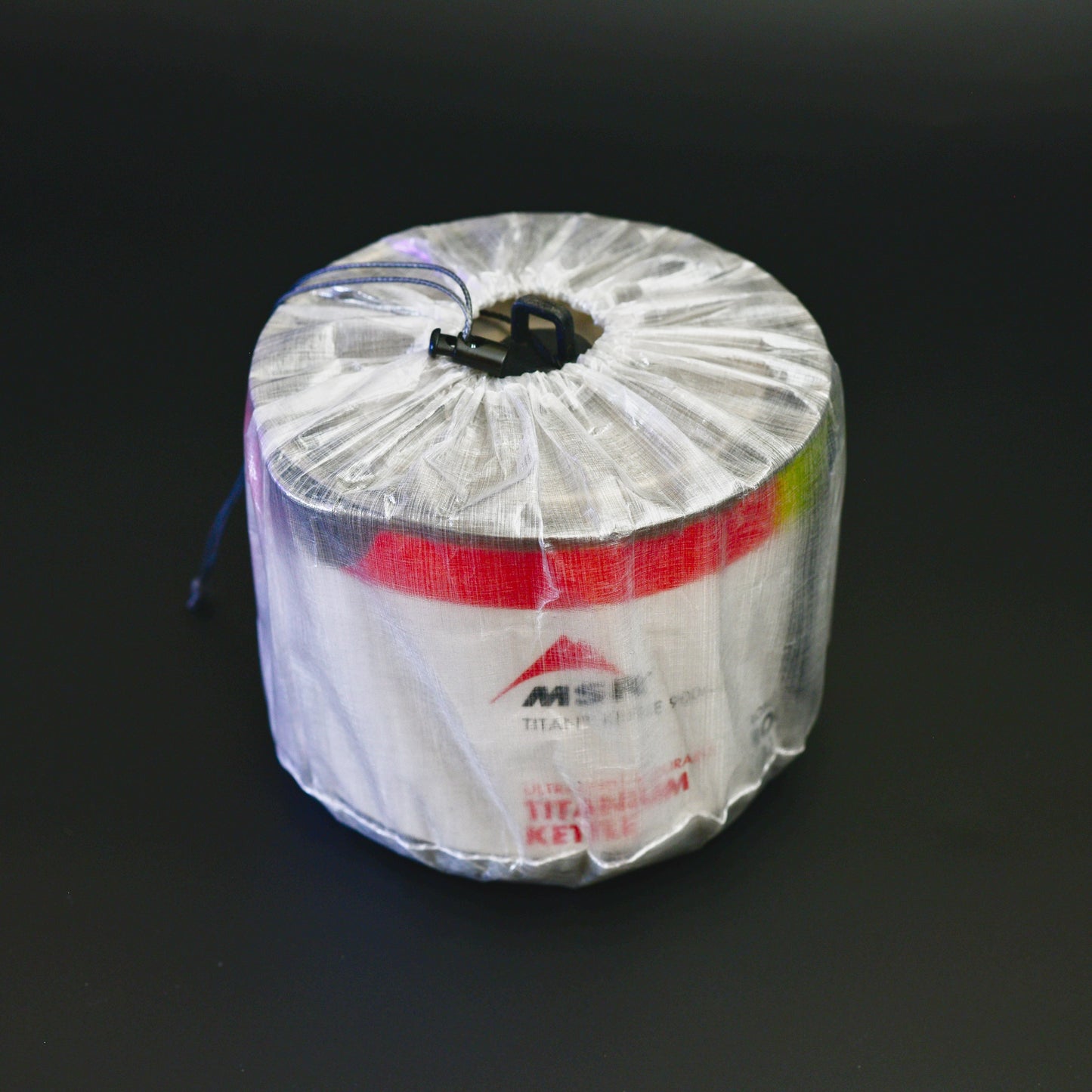 Ultralight Dyneema Composite Fabric stuff sack fitted over a 2024 MSR Titan Kettle 900ml on a black background
