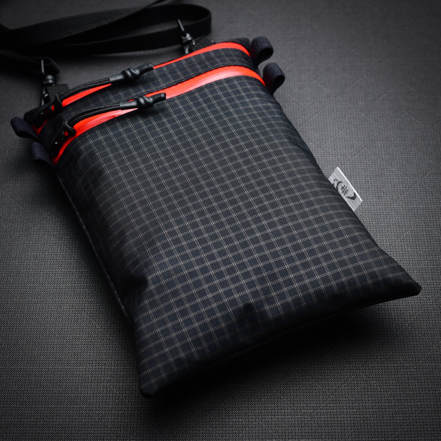 Ultralight Challenge UltraGrid twin zip shoulder bag with quick-release strap. Two YKK AquaGuard zip pockets for phone, wallet, passport and EDC gear.