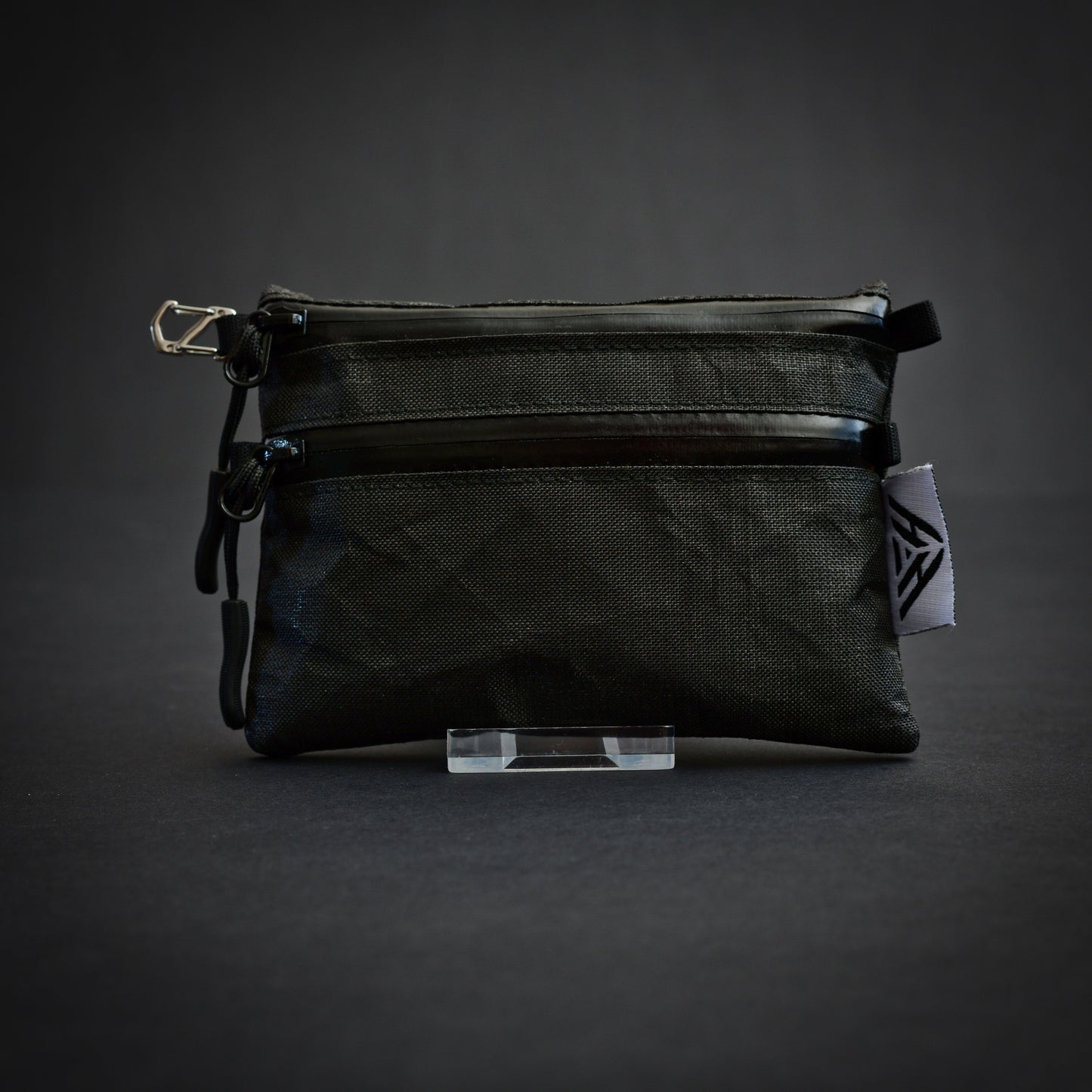 Front view of handmade Challenge Ultra 200X dual compartment utility pouch featuring two YKK AquaGuard zips, stainless steel micro S-biner and 17g ultralight construction.