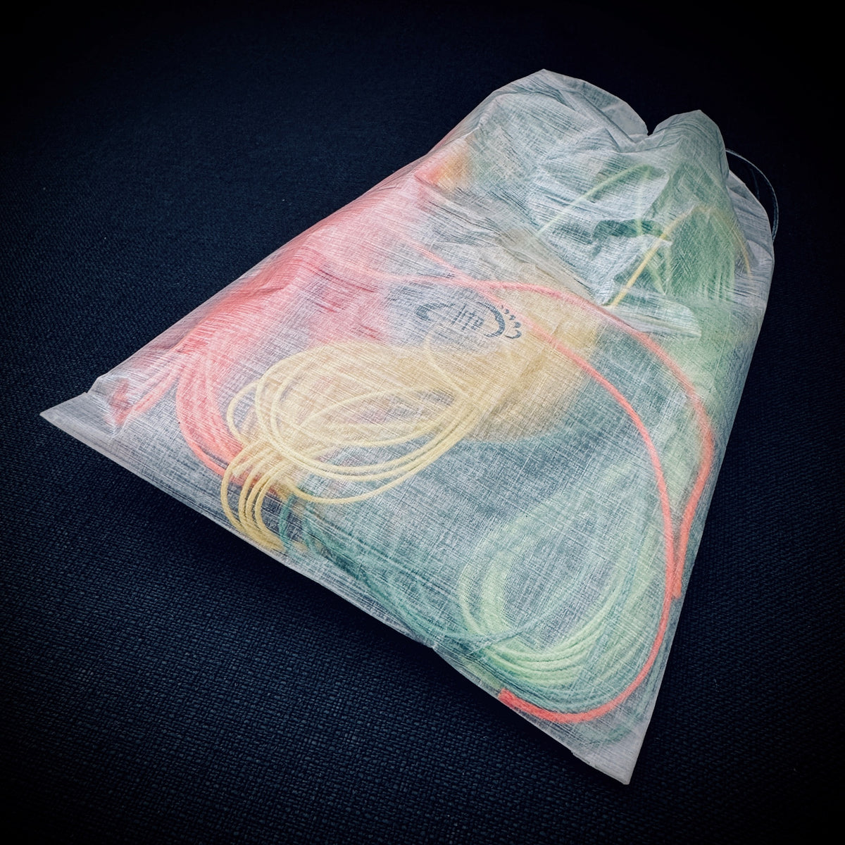 White bonded DCF ditty bag filled with coloured guylines and small camping accessories