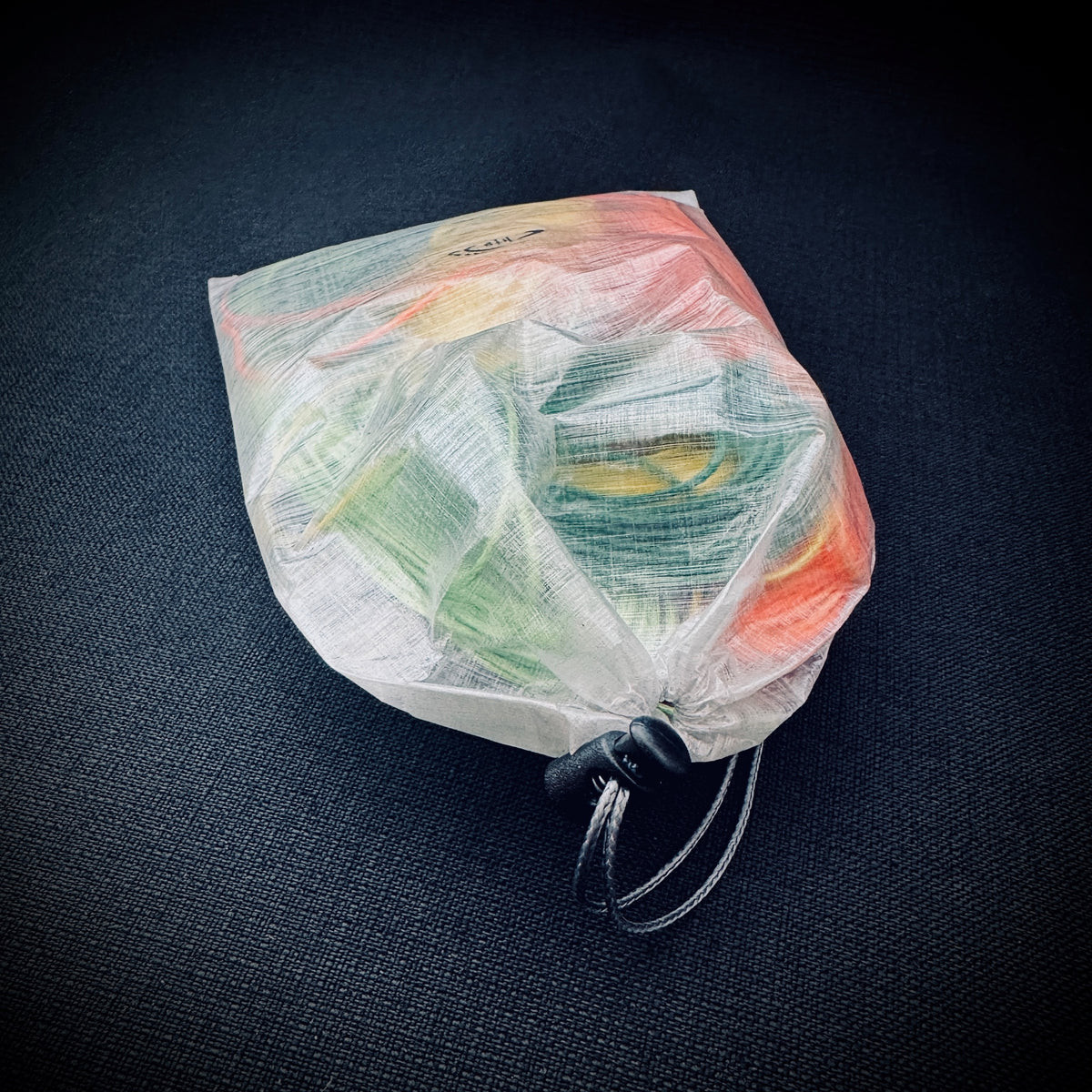 White bonded DCF ditty bag filled with coloured guylines and small camping accessories