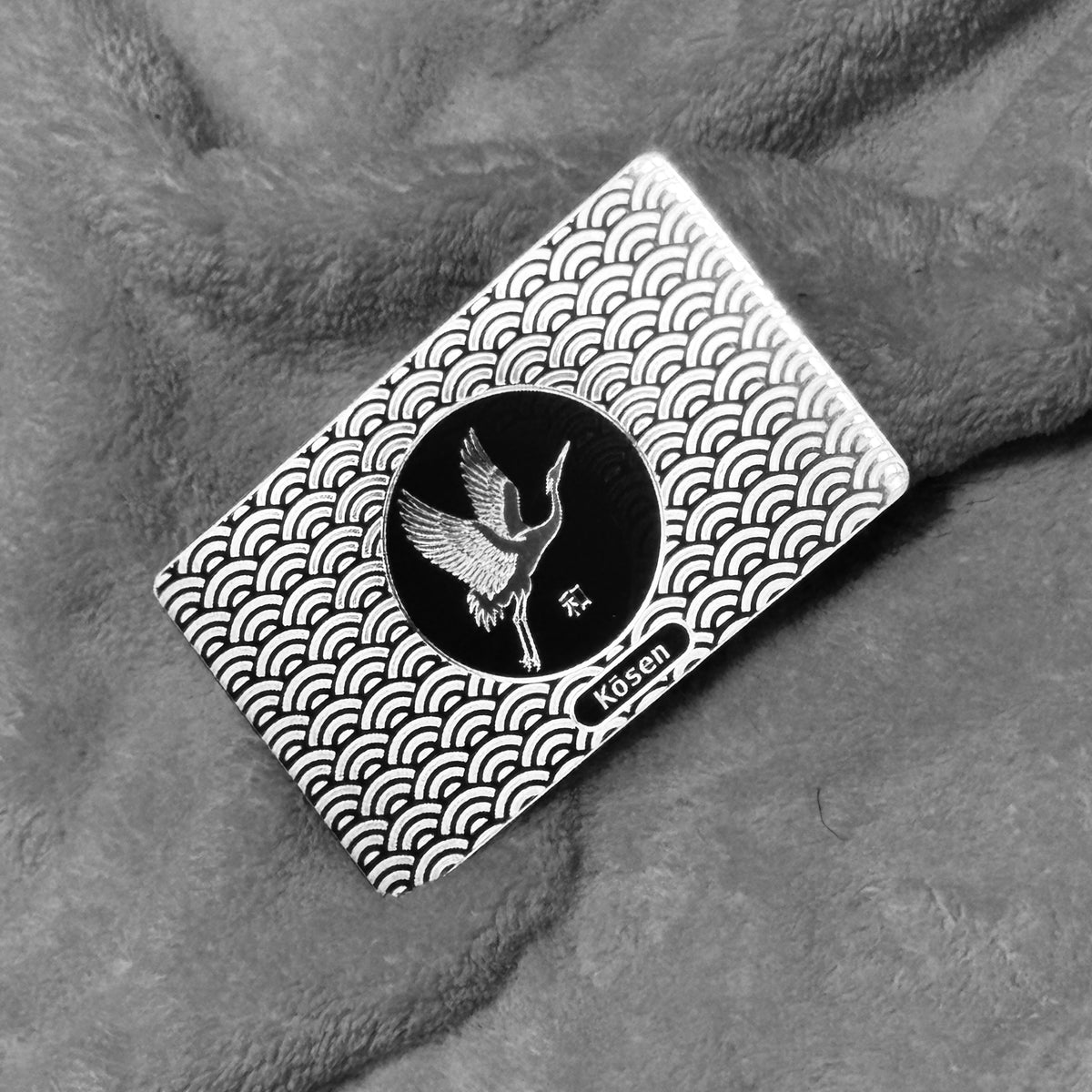 Landscape view of Kōsen Object 002 Harmony titanium art card showing crane artwork, Seigaiha pattern and silver-on-silver laser finish.