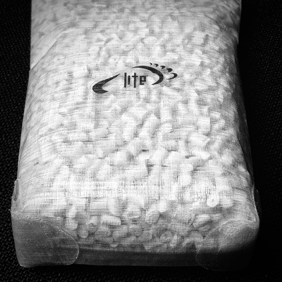 Close-up of the Tread Lite logo and bonded base of the DCF dry bag.