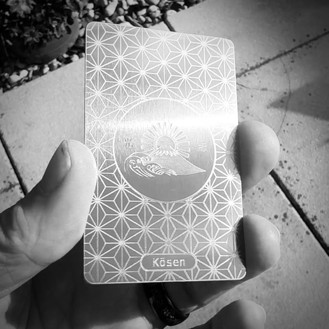 Video showing how the silver-on-silver laser finish of the Kōsen titanium art card changes with movement and angle of light.