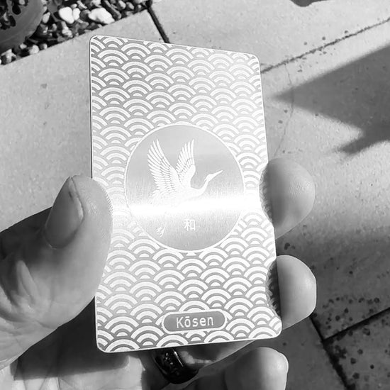 Video showing how the silver-on-silver laser finish of the Kōsen Harmony titanium art card changes with movement and angle of light.